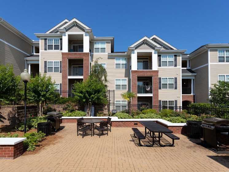 Garden Courtyard With Grills And Fireplace at Abberly Village Apartment Homes by HHHunt, South Carolina, 29169